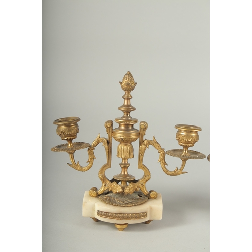 1231 - A GOOD PAIR OF  ORMOLU TWO LIGHT CANDLESTICKS on shaped marble bases.  8ins high.