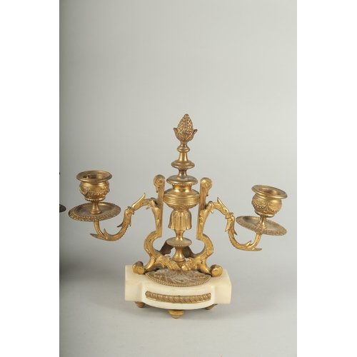 1231 - A GOOD PAIR OF  ORMOLU TWO LIGHT CANDLESTICKS on shaped marble bases.  8ins high.