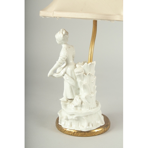 1239 - A WHITE PORCELAIN YOUNG LADY LAMP with a shade.