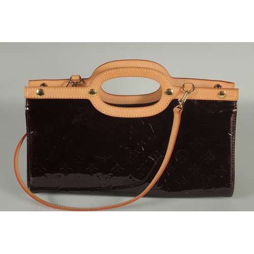 1243 - A GOOD LOUIS VUITTON BLACK PATENT LEATHER HAND BAG with beige handles. 13ins long, 7ins high, 3.5ins... 