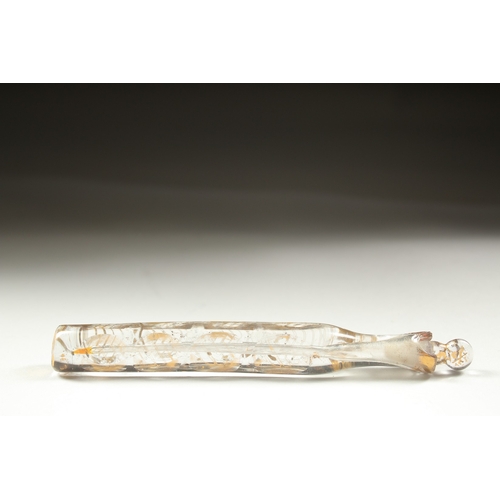 1258 - A LONG FACETED AND GILDED GLASS SCENT BOTTLE with gold stopper.  14cm long