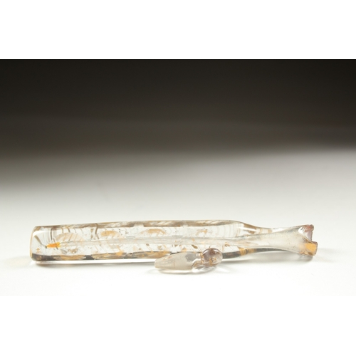 1258 - A LONG FACETED AND GILDED GLASS SCENT BOTTLE with gold stopper.  14cm long