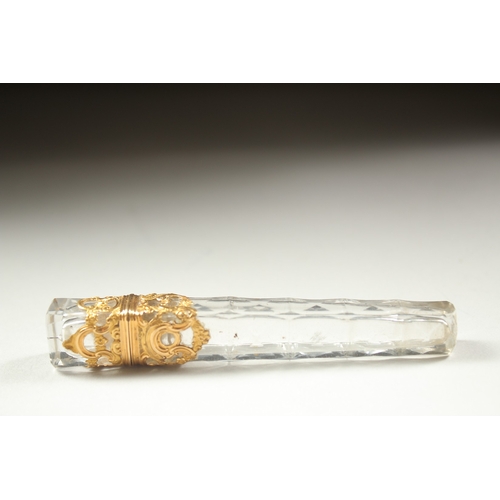 1259 - A GOOD FACETED AND GOLD MOUNTED LONG SCENT BOTTLE. 10cm long.