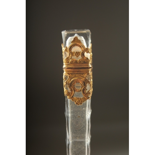 1259 - A GOOD FACETED AND GOLD MOUNTED LONG SCENT BOTTLE. 10cm long.