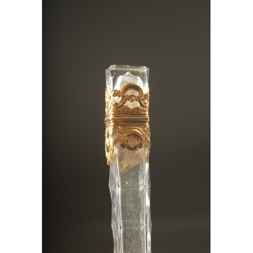 1259 - A GOOD FACETED AND GOLD MOUNTED LONG SCENT BOTTLE. 10cm long.