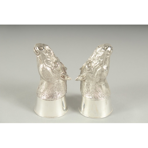 1284 - A PAIR OF .800 SILVER PLATED HORSES'S HEADS SALT AND PEPPERS. 7cm high.