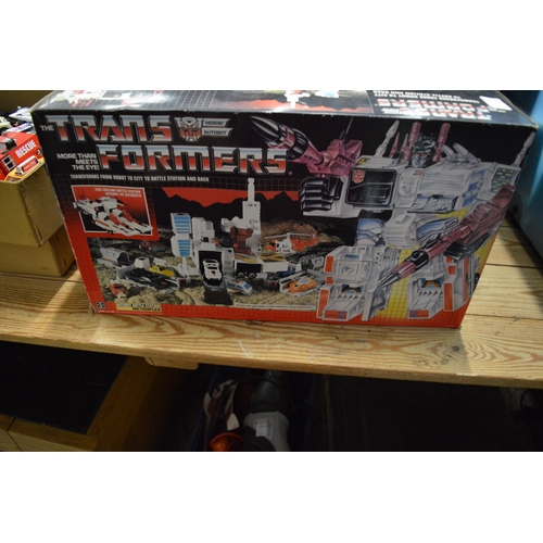 103 - A Star Wars At-At toy with box and two other boxed Transformer toys.