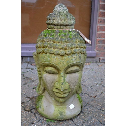 11 - A reconstituted stone garden ornament modelled as the head of a Buddha.