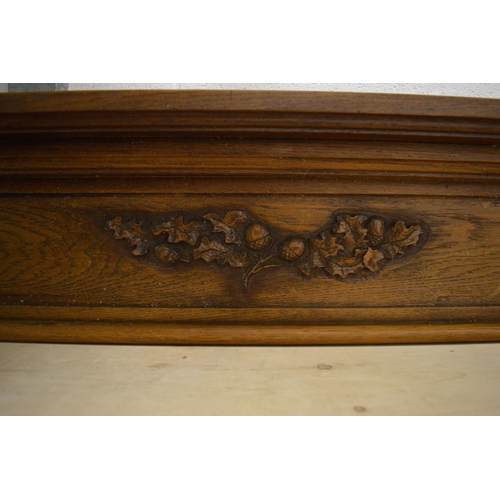 193 - An oak fire surround (opening size approx 125cm wide x 98cm high).