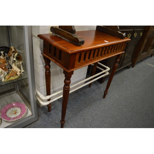 221 - A mahogany stained side table on turned and reeded legs.