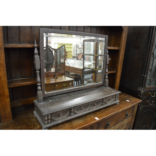 224 - An oak dressing table mirror with three drawers.