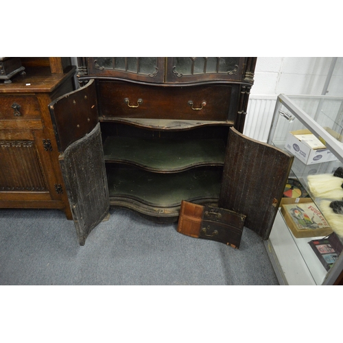 226 - A Neo-Classical revival mahogany serpentine fronted cupboard bookcase with pair of astragal glazed d... 