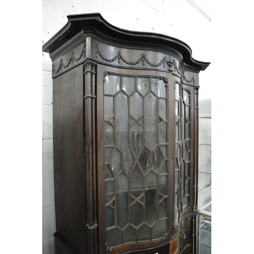 226 - A Neo-Classical revival mahogany serpentine fronted cupboard bookcase with pair of astragal glazed d... 