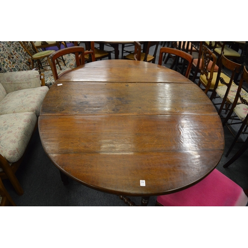 270 - An oak drop leaf gateleg dining table.