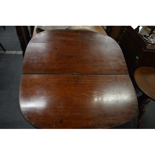 299 - A 19th century mahogany D shaped fold-over tea table (faults).