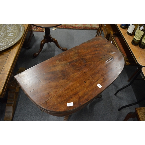 299 - A 19th century mahogany D shaped fold-over tea table (faults).