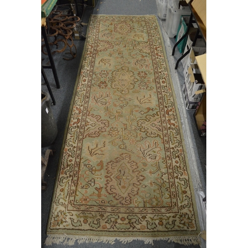 322 - A Persian design rug, cream ground with stylised decoration (worn) 280cm x 95cm.