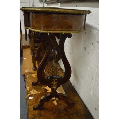 366 - A French parquetry decorated and ormolu mounted work table with lyre end supports (faults).