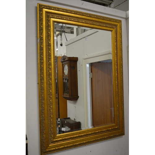 377 - A large decorative gilt framed wall mirror.