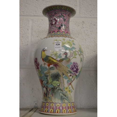 528 - A Chinese famille rose vase decorated with exotic birds.