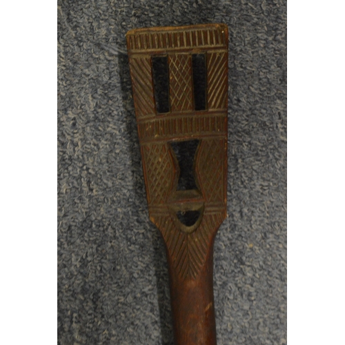 545 - An African carved wood spear shaped paddle.