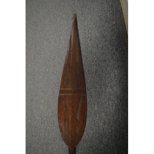 545 - An African carved wood spear shaped paddle.