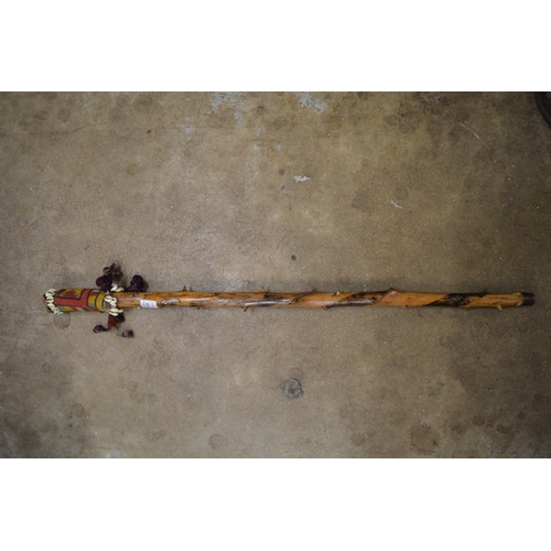 632 - An African staff with shell decoration.