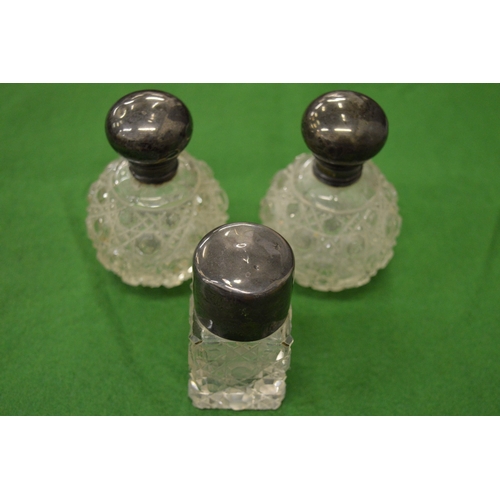 836 - A pair of small cut glass silver mounted scent bottles and another similar.