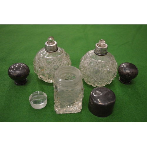 836 - A pair of small cut glass silver mounted scent bottles and another similar.