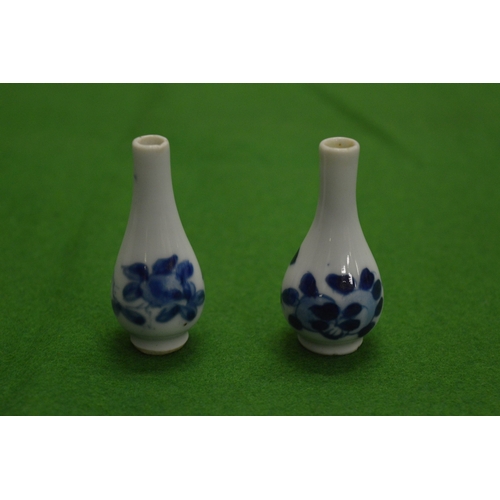 841 - A pair of miniature Chinese blue and white bottle vases.