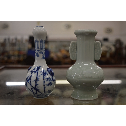 888 - A Chinese miniature celadon glazed vase together with a miniature Chinese blue and white vase.