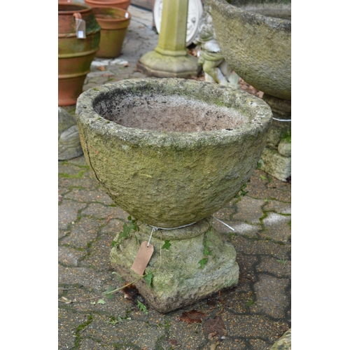 9 - A good pair of weathered reconstituted stone pedestal planters.