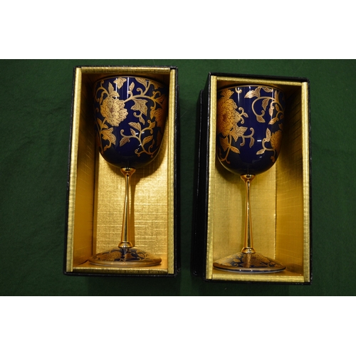 903 - A pair of gilt decorated porcelain goblets, boxed.