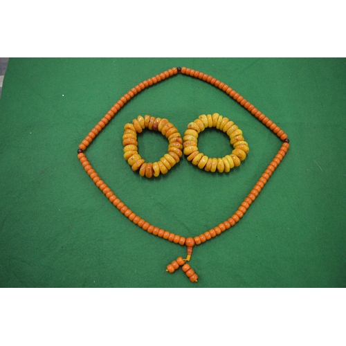 936 - A collection of amber style bead necklaces.