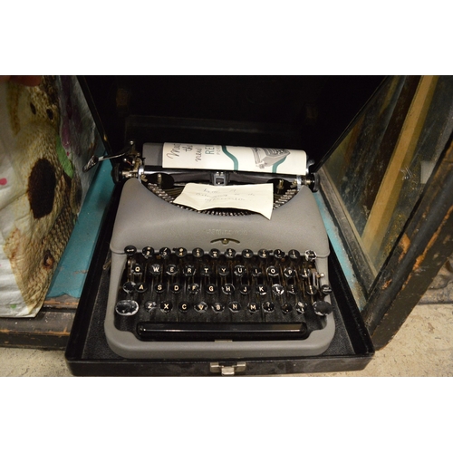 98 - Two old typewriters and a box containing gramophone records.