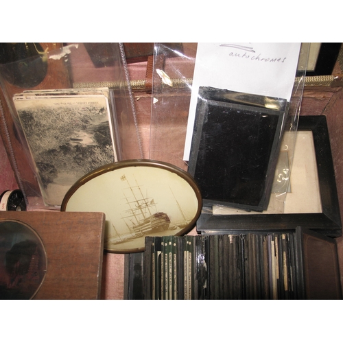 108 - PHOTOGRAPHY: a small suitcase of magic lantern slides, some in wooden frames, four small framed phot... 