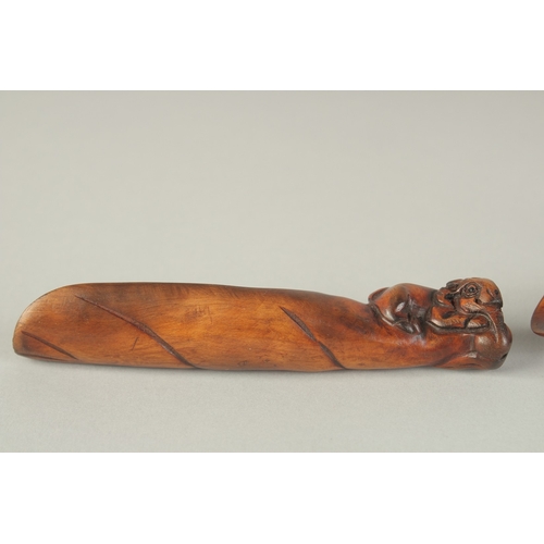 105 - TWO CARVED WOOD TEA SCOOPS, one carved with cockerel, the other carved with a goat, (2).