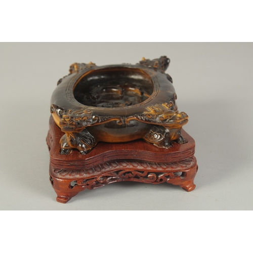 106 - A FINE AND UNUSUAL CHINESE CARVED TIGER'S EYE BRUSH WASHER, on a fitted carved hardwood stand, of ov... 