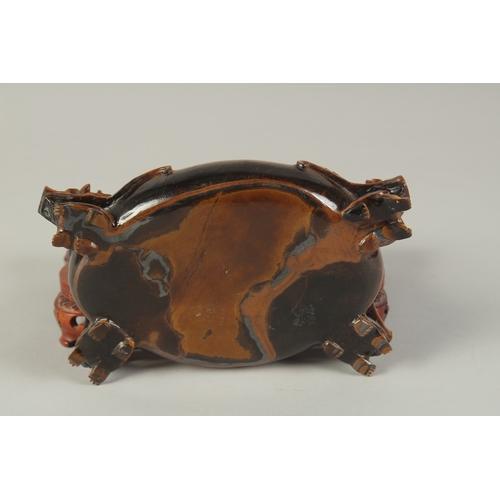 106 - A FINE AND UNUSUAL CHINESE CARVED TIGER'S EYE BRUSH WASHER, on a fitted carved hardwood stand, of ov... 