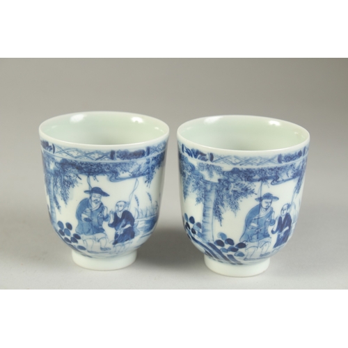 116 - A PAIR OF CHINESE BLUE AND WHITE PORCELAIN CUPS, painted with a fishing scene, the bases with four-c... 