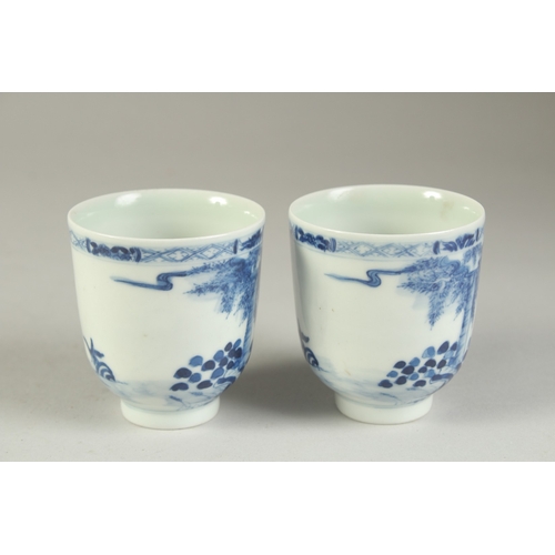 116 - A PAIR OF CHINESE BLUE AND WHITE PORCELAIN CUPS, painted with a fishing scene, the bases with four-c... 