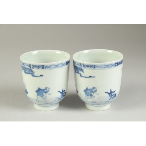 116 - A PAIR OF CHINESE BLUE AND WHITE PORCELAIN CUPS, painted with a fishing scene, the bases with four-c... 