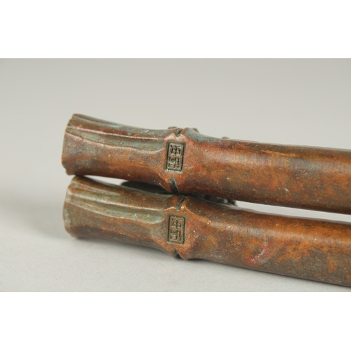 84 - A PAIR OF JAPANESE BRONZE PAPERWEIGHTS, with an insect on bamboo, the underside with mark, 19cm long... 