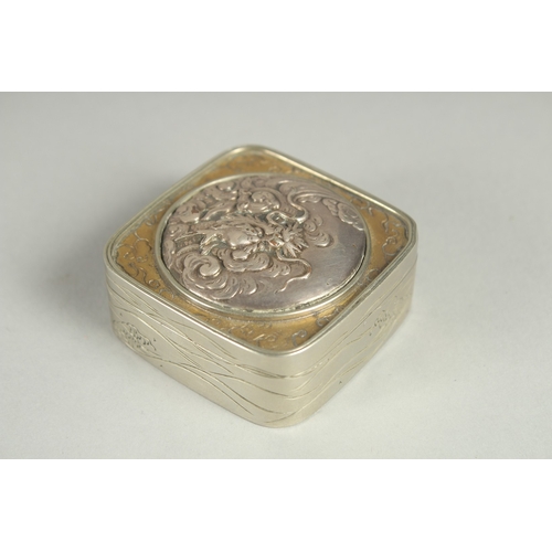 86 - A SMALL SIGNED JAPANESE WHITE METAL AND BRASS BOX, the hinged lid with relief dragon roundel, 5cm sq... 