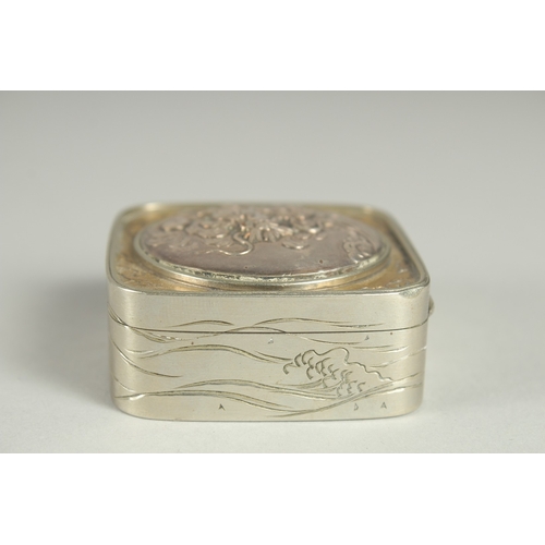 86 - A SMALL SIGNED JAPANESE WHITE METAL AND BRASS BOX, the hinged lid with relief dragon roundel, 5cm sq... 