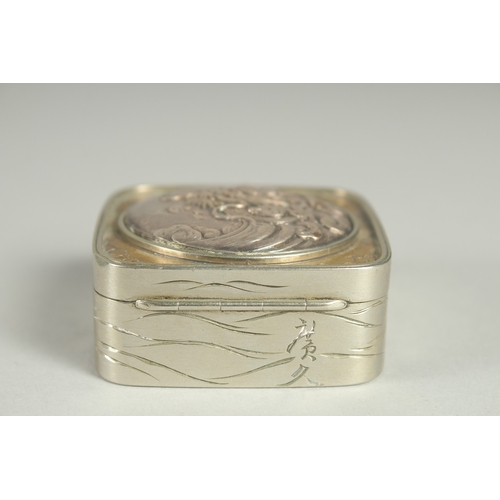 86 - A SMALL SIGNED JAPANESE WHITE METAL AND BRASS BOX, the hinged lid with relief dragon roundel, 5cm sq... 