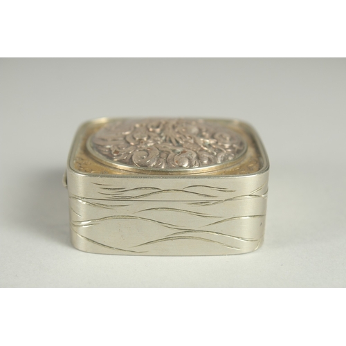 86 - A SMALL SIGNED JAPANESE WHITE METAL AND BRASS BOX, the hinged lid with relief dragon roundel, 5cm sq... 