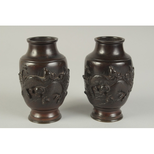 88 - A PAIR OF JAPANESE BRONZE VASES, relief decorated with rams and flora, 13.5cm high.