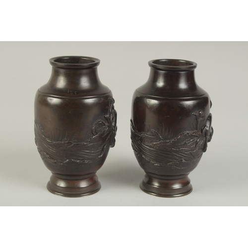 88 - A PAIR OF JAPANESE BRONZE VASES, relief decorated with rams and flora, 13.5cm high.