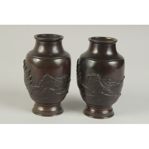 88 - A PAIR OF JAPANESE BRONZE VASES, relief decorated with rams and flora, 13.5cm high.